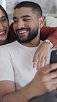 Couple, hug and laughing with smartphone, home or watching funny videos with partner, humor and love. Online, entertainment and people with mobile for comedy movie, relax or bonding on couch in house