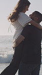 Happy, kiss and couple on beach with spin for bonding on holiday, getaway and summer vacation. Dating, flare and man with woman by ocean for relationship, connection and romance outdoor on weekend