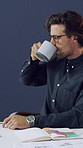 Businessman, designer and drinking with coffee in office for business plan or interior design. Man, employee or creative with mug, laptop or caffeine for morning agenda, renovation project or startup