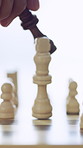 Hand, person and chessboard with queen for checkmate victory, winning move and strategy success. Player, knock and chess piece for achievement, defeat opponent and game over with tournament milestone