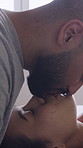 Love, couple and kiss on bed, home and smile with partner on break, bonding and laughing in bedroom. Happiness, man and woman on holiday, affection and relax with spouse on weekend, care or together