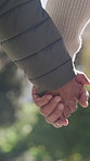 Holding hands, walking and senior couple in nature for fresh air, bonding and connection in neighborhood. Retirement, marriage and elderly man with woman for affection, love and relationship outdoor
