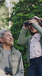 Grandfather, child and bird watching with binocular in garden to explore, species book or knowledge. Learning, grandpa and girl kid with field glasses for backyard observation, sightseeing or bonding