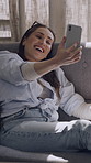 Woman, happy and video call on sofa with talk in home for contact, relax and discussion on web. Person, smile and smartphone on couch for virtual chat, mobile app and conversation in lounge at house