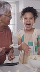 Baking, laugh and child with grandparents in kitchen for learning, helping and prepare dessert. Grandpa, grandma and girl with playful relationship for bonding, love and ingredients for cake recipe
