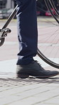 Legs, walking or businessman in city with bike, urban travel or sustainable commute in morning trip. Wheel, stroll or employee with bicycle, eco friendly transport or carbon footprint at start of day