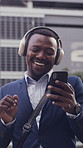 Businessman, dance and phone in city with headphones, streaming music and morning commute for job. Happy black person, walk and rhythm in urban town with audio tech, online radio and travel to work.