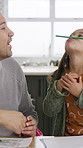 Dad, girl and laugh with joke for education, bonding and balance with pencil on lips in home. Happy people, father and child with funny game, playful and color book with learning at family house
