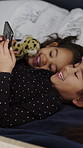 Phone, movie and children in home at night for watching series, show or video together on weekend. Friends, technology and girl kids with cellphone for streaming film with bonding in bedroom at house