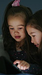 Tablet, show and children in home at night for watching series, movie or video together on weekend. Friends, bonding and girl kids with digital technology for streaming film in bedroom at house.