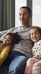 Father, children and watching tv on sofa with relax, embrace and bonding together on weekend break. Dad, girl kids and hug in home with streaming service, online cartoon and connection on holiday.