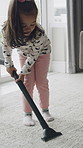 Cleaning, kid and vacuum carpet in home for dirt removal, hygiene or learning responsibility. Housework, independent girl or appliance on mat for domestic chores, dust prevention or child development