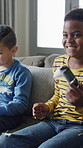 Happy boy, winner and gamer with friend on sofa for online entertainment or victory in home. Excited children, kids or dancing with playful game on console for celebration, fun competition or success