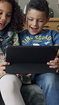 Tablet, kids and funny friends in home with game, smile or comedy movies on internet. House, boys and happy girl with technology for relax, streaming cartoon or laugh together with app in living room