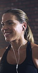 Happy woman, fitness and listening with earphones in gym for music, audio streaming or playlist. Active, female person or smile with sound app or sweat for entertainment or wellness in health club