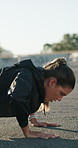 Fitness, woman and push up workout in road for core stability, strength training or chest muscles. Sweat, athlete and functional exercise in city for intense challenge, health or endurance with flare