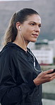 Fitness, earphones and woman in city, listening to music and exercise for health benefits. Outdoor, person and cellphone for sound, wellness app or podcast for motivation, radio or audio for playlist