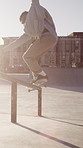 Man, grind and balance with skateboard in city for trick, training and extreme sports with action. Skateboarder, person and jump on rail for stunt at skatepark, exercise or practice for hobby outdoor