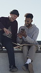 Skateboard, men and friends with smile, smartphone for social media, funny meme and laughing. Outdoor, skaters or happy people with break, internet and cellphone for online humor, relax or connection