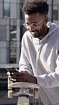 Skateboard, typing or man with phone in city, stunt technique research or message for communication. Urban, smile or person with texting for online chat, mobile or browsing internet for skating forum