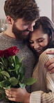 Man, woman and roses in home with gift, surprise and flowers for marriage anniversary in kitchen. Couple, smile and floral bouquet with love, present or celebration for valentines day in house