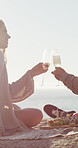 Beach, picnic and couple with champagne, toast and bonding together with vacation and marriage. Ocean, alcohol and man with woman for relax, anniversary and celebration with holiday, care and cheers
