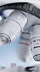 Science, nosepiece and microscope in lab, closeup and medical research for cure development or study. Empty, clinic and equipment for innovation, health and pharmaceutical investigation and biotech