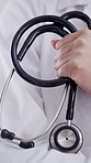 Doctor, hands and stethoscope for healthcare, medical help or service in hospital. Person, closeup or cardiology expert with arms crossed, equipment or uniform for heartbeat or checkup in clinic