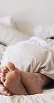 Relax, feet and couple with cuddle in bed for love, affection and marriage commitment for weekend bonding. Comfort, rest and people with romance in home, partner connection and healthy relationship