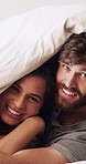 Blanket, cuddle and face with couple in bed together for moment, morning bonding or wake up. Cover, funny and love with happy people in bedroom of home for relationship security, support or wellness
