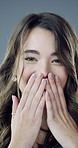 Face, woman and wow with smile in studio for good news, gossip and listening to rumor. Portrait, female person and shocked for announcement, omg reaction and happy with funny drama on gray background