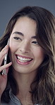 Woman, phone and happy with talk in studio with funny story, gossip and discussion on background. Girl, smile and smartphone with conversation for joke, chat and laugh with contact on mobile network