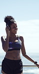 Dancing, fitness and woman with headphones by beach with music for workout, training or challenge. Audio tech, sports and female person listening to playlist for exercise, health or active by ocean.