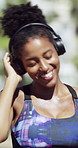 Dancing, fitness and woman with headphones outdoor with music for workout, training or challenge. Audio tech, sports and female person listening to playlist for exercise, health or active in nature.