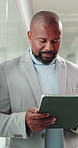 Black man, tablet and typing at office with proposal, policy review and smile by window at insurance company. Mature person, broker and tech with app, feedback and project at risk management agency