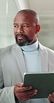Black man, tablet and thinking at office with proposal, policy review and night by window at insurance company. Mature person, broker and tech with app, feedback and project at risk management agency
