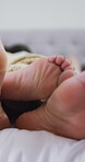 Couple, feet and love on bed, home and bonding with partner on anniversary, commitment and intimate. Sleeping, together and people on break, closeup and messy clothes in bedroom, romance or care