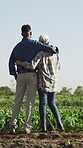 Agriculture, farmer and couple with hug on field for crop management, support and land gratitude. Love, back of interracial people and embrace outdoor for farming success and pride for plant health