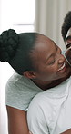Black couple, happy and hug on bed in home with connection, care and bonding in relationship. African man, woman and smile with embrace, conversation and laugh with love in morning at apartment