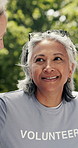 Old woman, volunteer or talk in park with charity group, project and planning for non profit service. Senior person, conversation and support outdoor with NGO team, outreach or social responsibility.