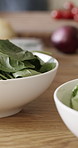 Kitchen counter, salad and food in home for lunch with organic ingredients, nutrition and wellness. Bowl, plate and meal preparation with spinach, diet and cooking for party in morning at apartment
