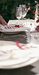 Hands, setting table and outdoor at Christmas for lunch, candy cane or plates with decoration. Person, creativity and cloth for dining, display or presentation for social event at xmas in backyard