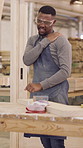 Carpenter, shoulder pain and black man in workshop, joint injury and manufacturing schedule. Muscle tension, furniture industry and person in factory, health risk and stretching for tension relief