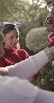Outdoor, friends and women with ornaments, Christmas tree and happy on festive season or decoration. Backyard, reunion and people with xmas tradition, home and social gathering on December holiday