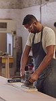 Carpentry, sanding and man with machine in workshop for furniture, smooth surface and woodworking. Factory, carpenter and person with sandpaper tool for restoration, repair or wood for timber project