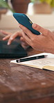 Person, hands and finance with phone on laptop for small business or pottery in store. Closeup, employee or ceramic artist with mobile smartphone, computer or book for financial planning or checklist