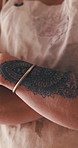 Creativity, person or arms crossed with tattoo design for permanent ink, self expression or art. Identity, designer hands or paisley artwork for forearm aesthetic, cultural decoration or unique style