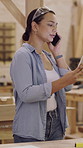 Woman, carpenter and tablet with phone call in workshop for woodwork project or planning. Female person, carpentry or talking with mobile smartphone or technology for lumber design or construction