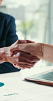 Business people, meeting and documents with handshake for partnership, b2b or agreement in office. Closeup, employees or colleagues shaking hands with greeting for hiring or recruiting in workplace