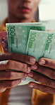 Hands, counting cash and budget in home with financial planning, bills or savings for wealth. Person, paper money and check for value, payment or review for spending power with income at apartment